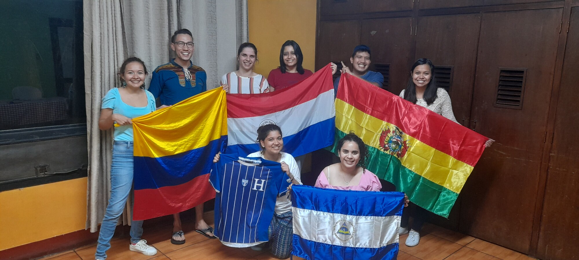 In August 2022, MCC Guatemala-El Salvador hosted the YAMEN* orientation for Spanish-speakers. Here, each participant shows off their country flag: (from left to right), above, Lilibeth Guzmán (Colombi